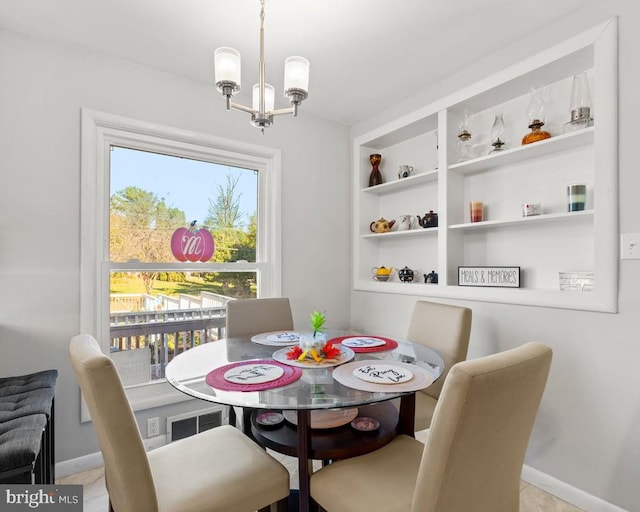 dining space featuring light tile patterned floors and a chandelier