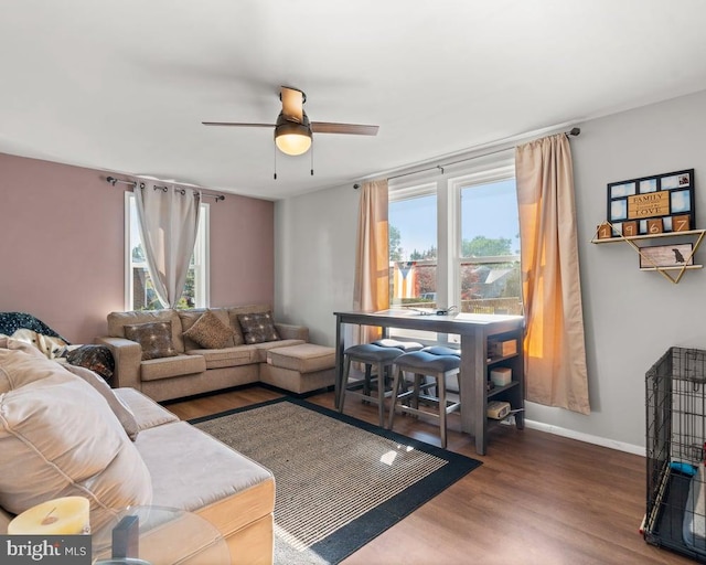 living room featuring hardwood / wood-style flooring, ceiling fan, and a wealth of natural light