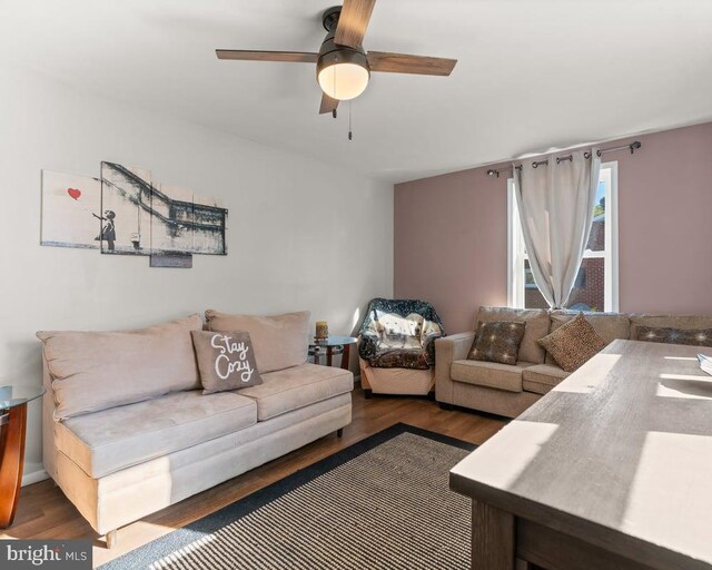 living room with ceiling fan and dark hardwood / wood-style floors