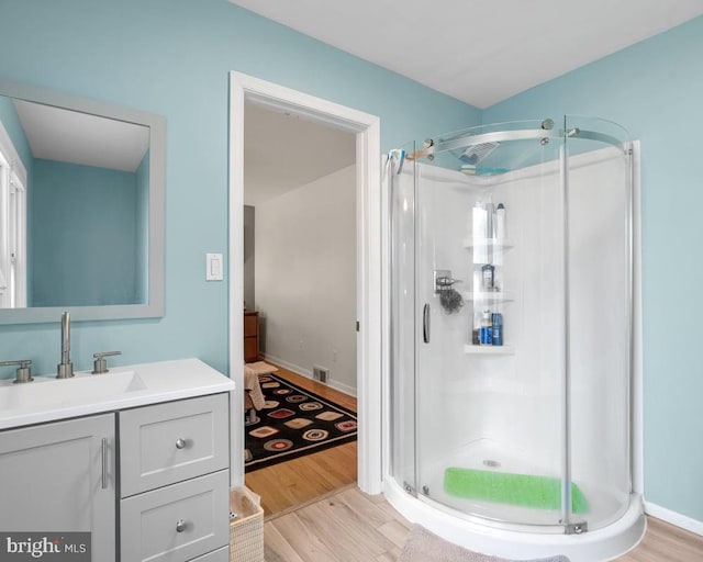 bathroom featuring vanity, hardwood / wood-style flooring, and an enclosed shower