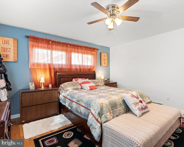 bedroom with wood-type flooring and ceiling fan