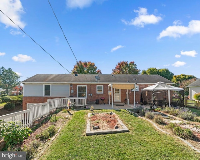 view of front of house with a patio and a front lawn