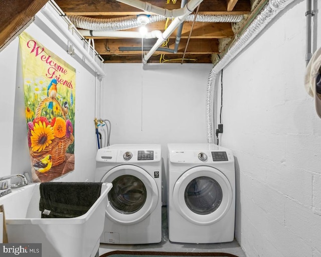 clothes washing area with sink and washer and clothes dryer