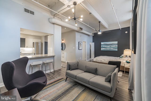 living room featuring a chandelier, beam ceiling, and hardwood / wood-style flooring