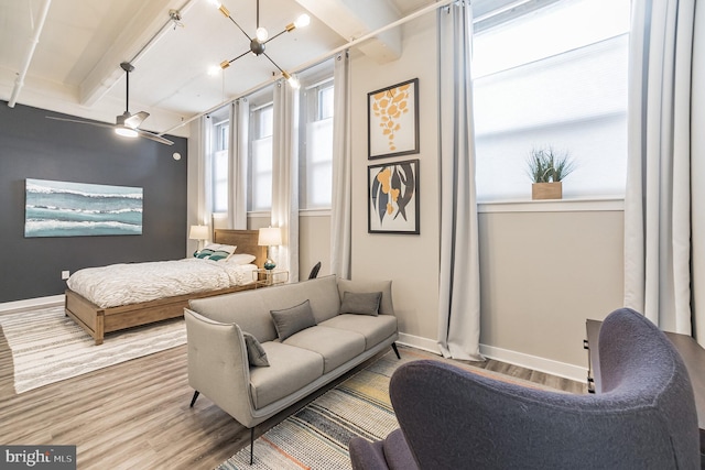 bedroom featuring hardwood / wood-style flooring and beamed ceiling