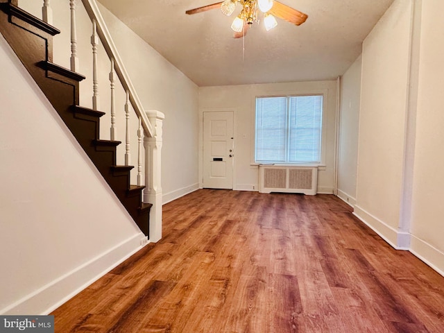 entrance foyer with ceiling fan, light hardwood / wood-style flooring, and radiator heating unit