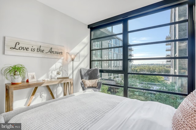 bedroom featuring a wall of windows and multiple windows