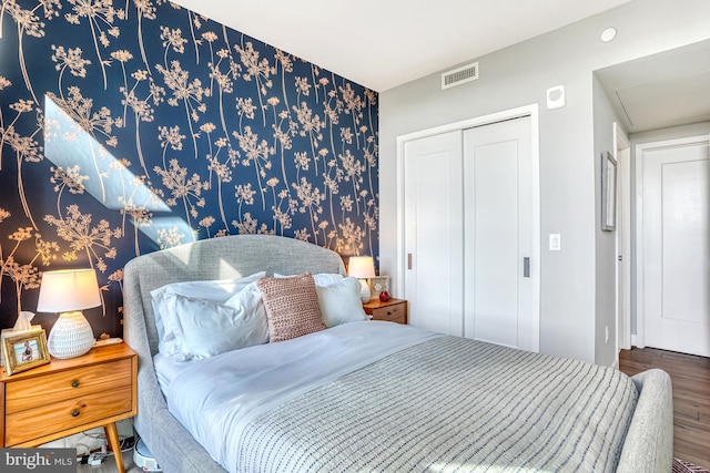 bedroom with hardwood / wood-style flooring and a closet