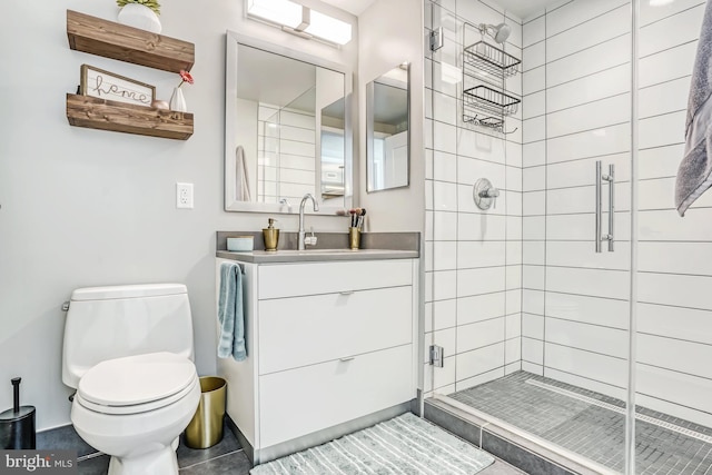 bathroom featuring vanity, walk in shower, tile patterned floors, and toilet