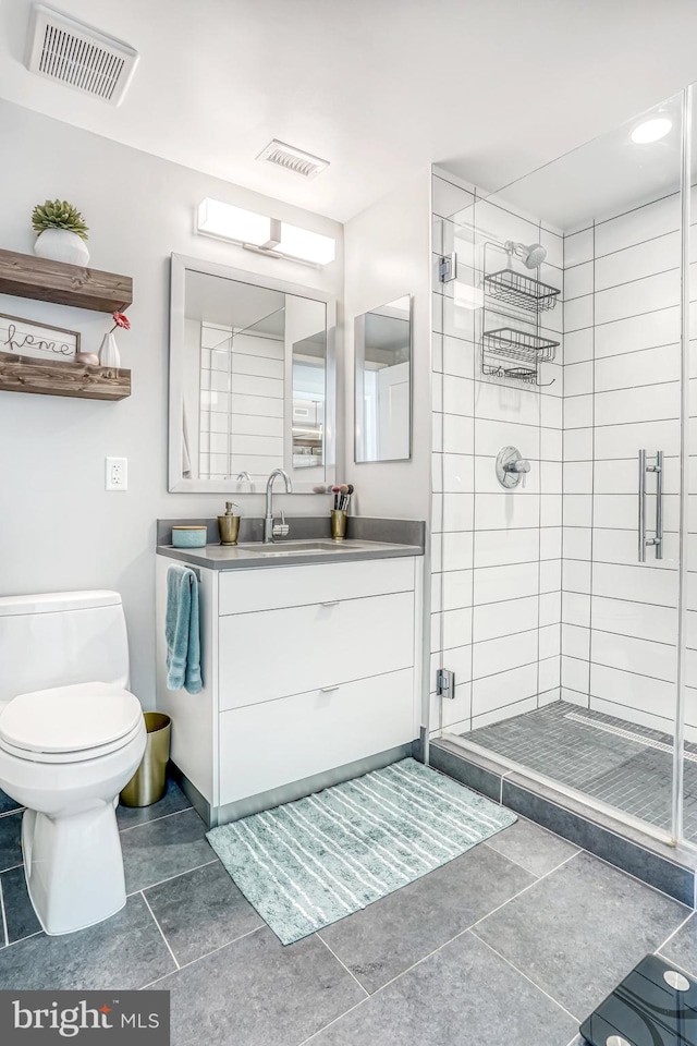 bathroom with walk in shower, vanity, toilet, and tile patterned flooring