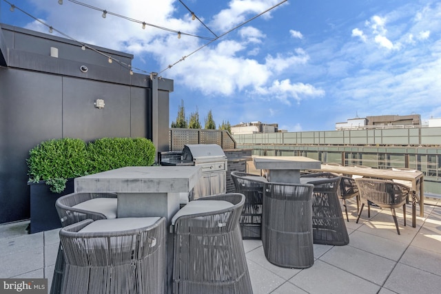 view of patio featuring a bar, grilling area, and area for grilling