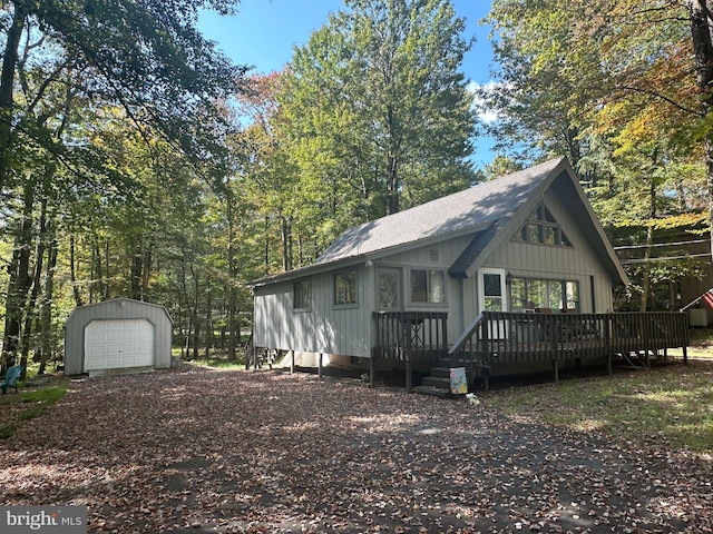 exterior space with a deck, a garage, and an outdoor structure