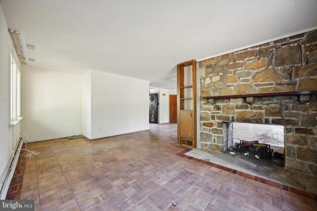 unfurnished living room featuring parquet floors, a baseboard heating unit, and a fireplace