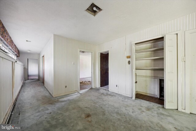 unfurnished bedroom with light colored carpet and a closet