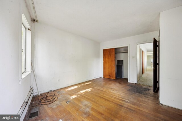 empty room with hardwood / wood-style floors