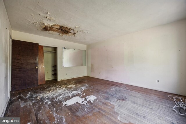 unfurnished bedroom featuring a closet and wood-type flooring