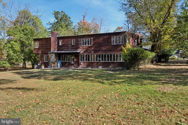 rear view of property with a yard