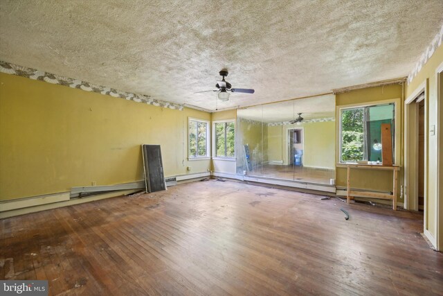 empty room with hardwood / wood-style floors, a textured ceiling, and ceiling fan