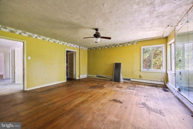 spare room with a textured ceiling, hardwood / wood-style flooring, and ceiling fan