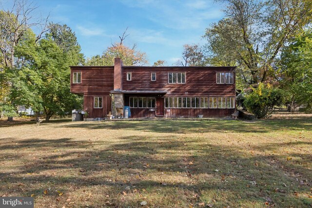 rear view of house with a yard