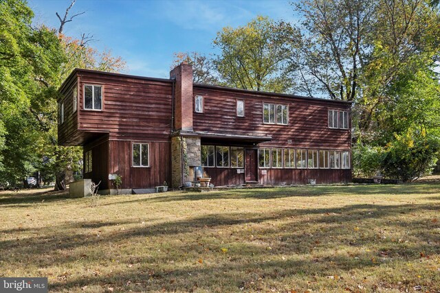 rear view of house with a yard