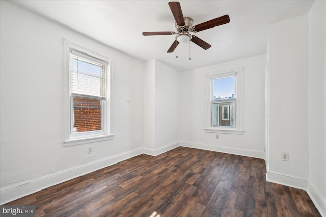 unfurnished room featuring dark wood-type flooring and ceiling fan