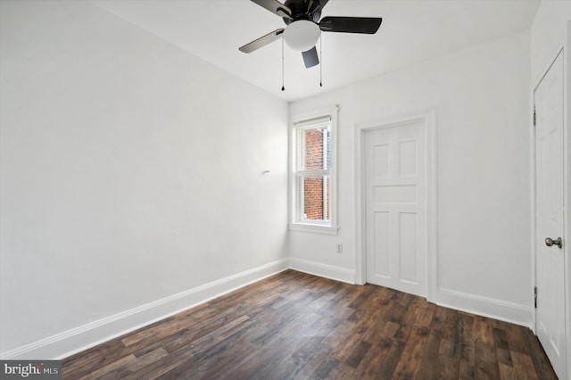 unfurnished bedroom featuring ceiling fan and dark hardwood / wood-style flooring