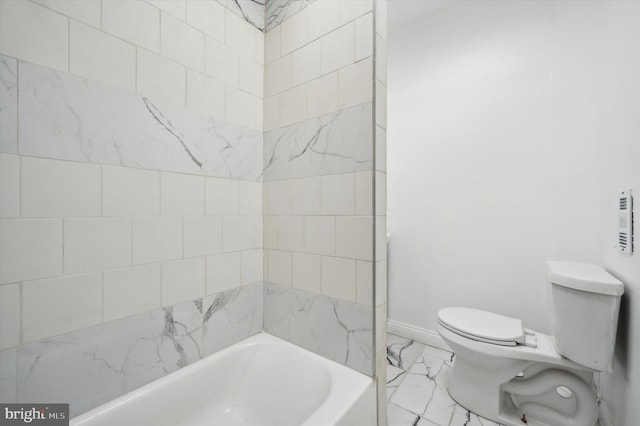 bathroom with a washtub and toilet