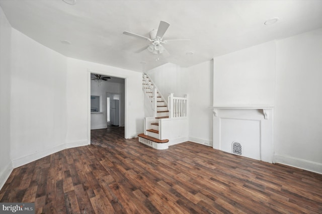 unfurnished living room featuring ceiling fan and dark hardwood / wood-style floors