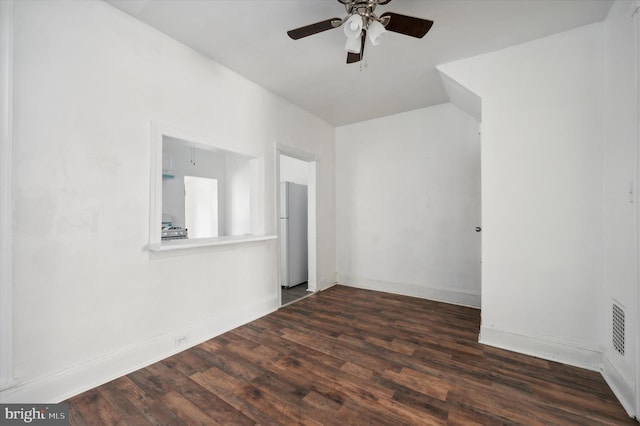 empty room with dark hardwood / wood-style flooring and ceiling fan