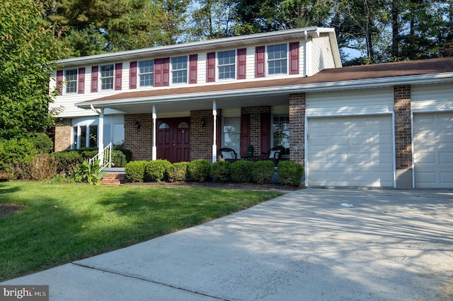 view of front of house featuring a garage, a porch, and a front lawn