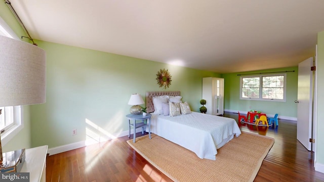 bedroom with hardwood / wood-style flooring