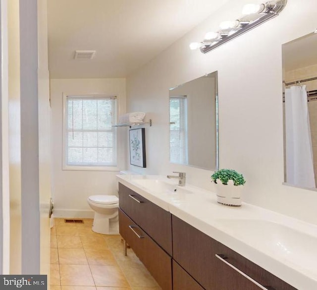 bathroom featuring vanity, toilet, and tile patterned floors