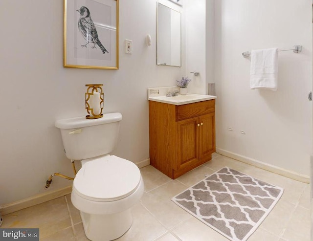 bathroom with tile patterned flooring, vanity, and toilet