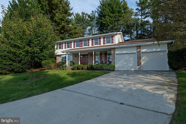 view of front of property with a garage, a porch, and a front yard