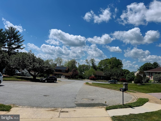 view of road with sidewalks and curbs
