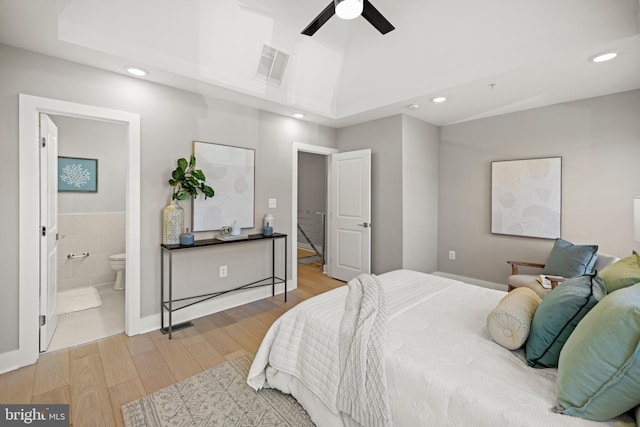 bedroom featuring ceiling fan, wood-type flooring, and ensuite bathroom