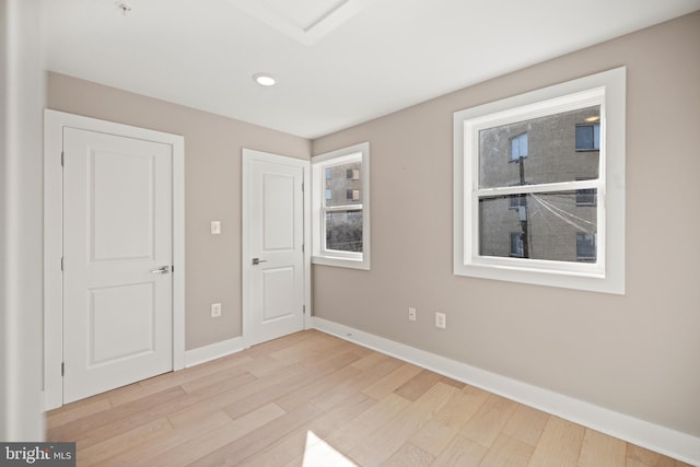 unfurnished bedroom featuring light wood-type flooring