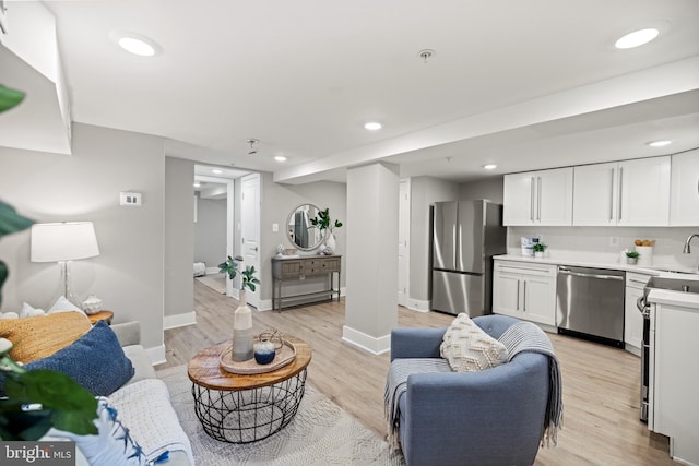 living room featuring light hardwood / wood-style floors and sink