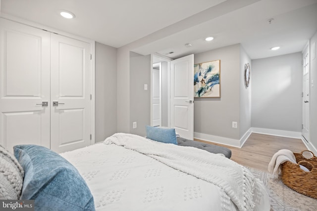 bedroom with a closet and light hardwood / wood-style flooring