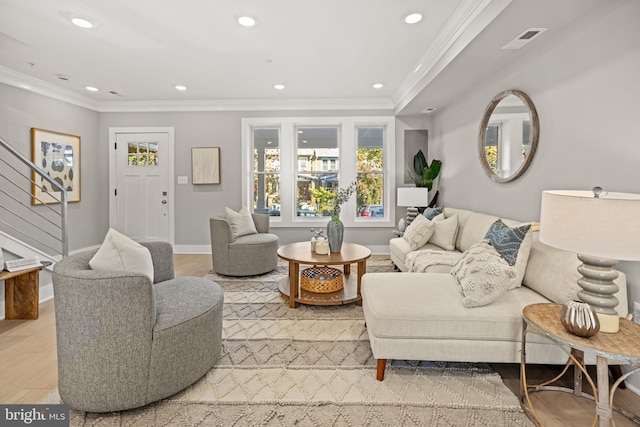 living room featuring ornamental molding and light hardwood / wood-style floors