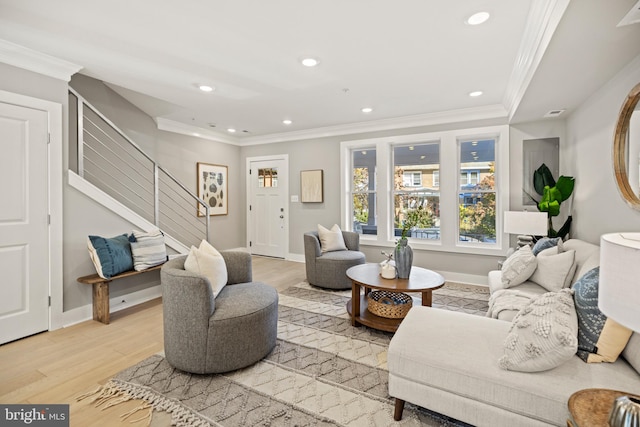 living room featuring light hardwood / wood-style floors and ornamental molding