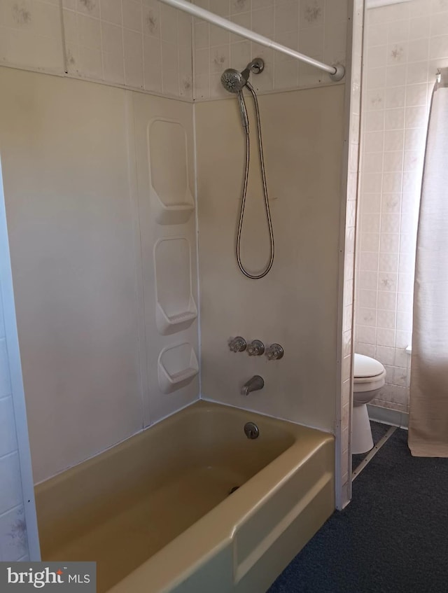 bathroom with toilet and tiled shower / bath combo