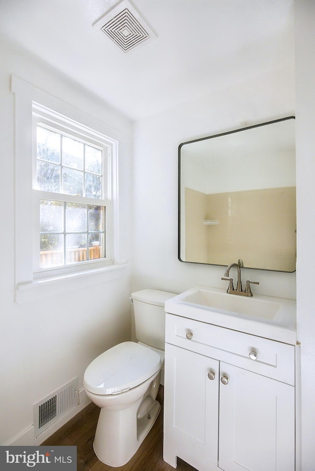 bathroom featuring hardwood / wood-style flooring, vanity, and toilet