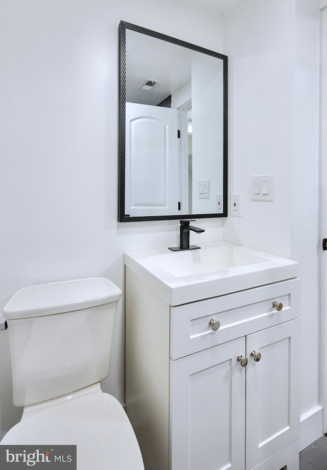 bathroom with vanity and toilet