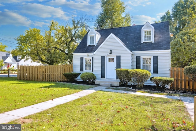 cape cod home featuring a front yard