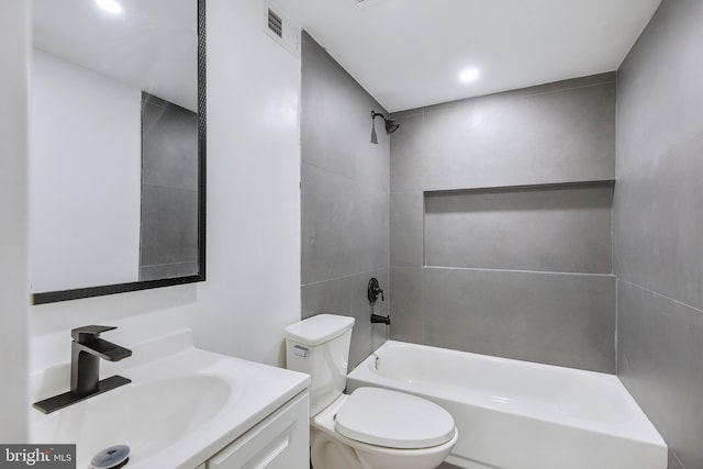 full bathroom featuring vanity, toilet, and tiled shower / bath combo