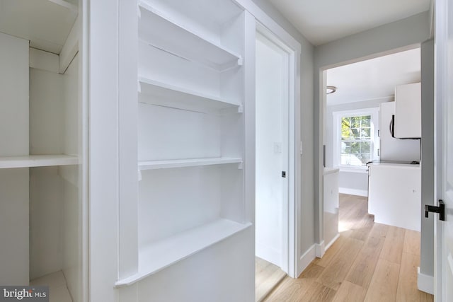 hallway with light wood-type flooring