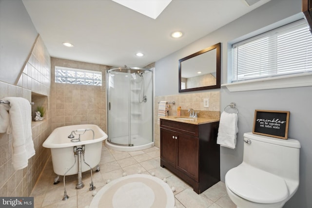 full bathroom featuring vanity, independent shower and bath, tile patterned floors, tile walls, and toilet