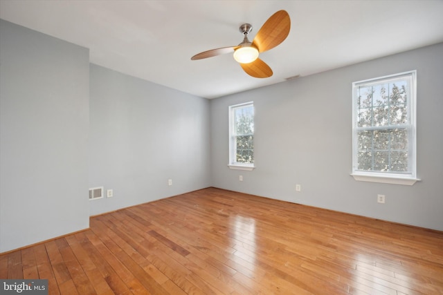 spare room featuring ceiling fan and light hardwood / wood-style flooring